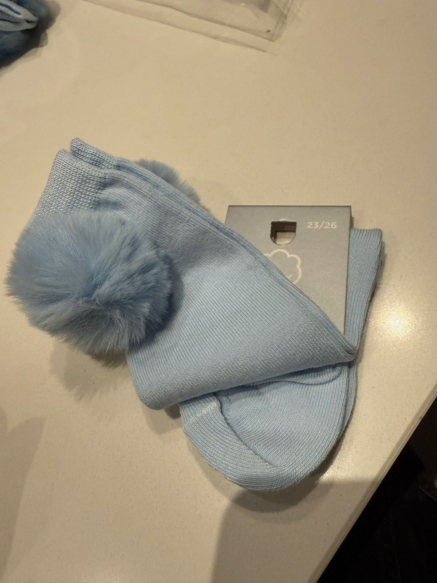 Kniekousjes met pompon Babyblauw